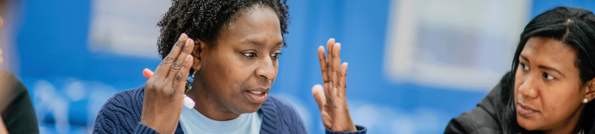 Woman speaking at a community meeting