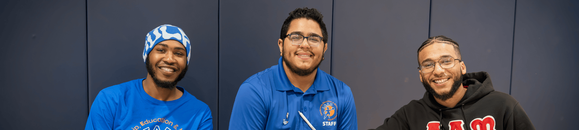 three men sitting at training session